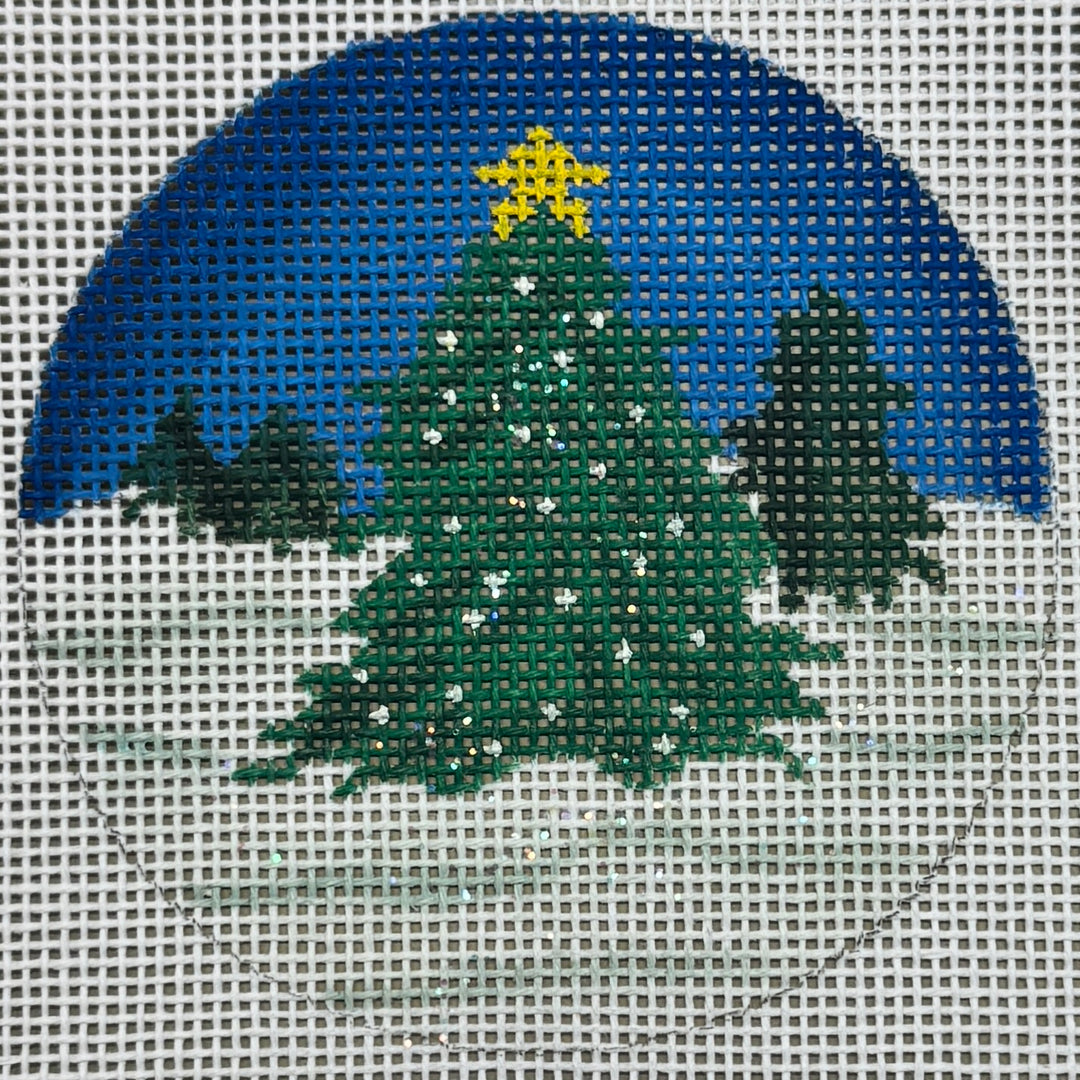 CHRISTMAS TREE IN FIELD OF SNOW